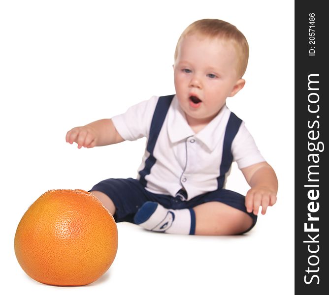 The child reaches out to orange, the focus on oranges, isolated on a white background. The child reaches out to orange, the focus on oranges, isolated on a white background