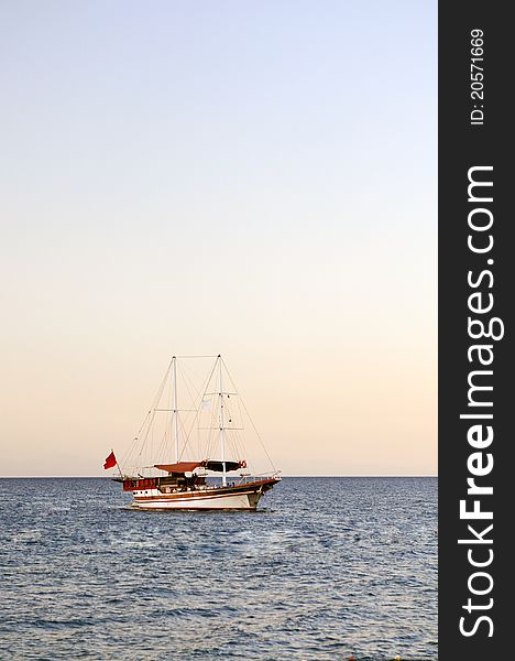 Yacht at sunset, at anchor