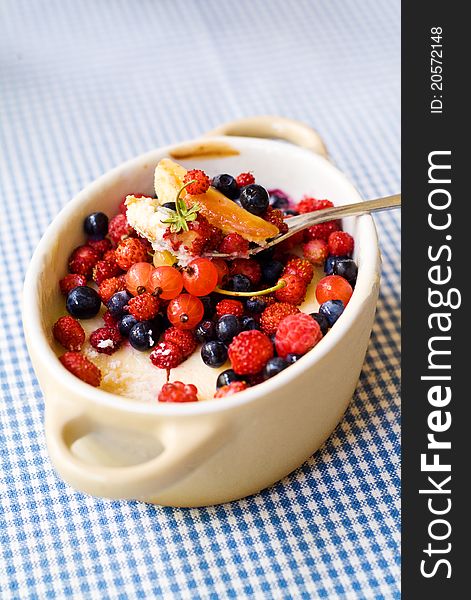 Small pot with cheesecake and wild berries. Small pot with cheesecake and wild berries