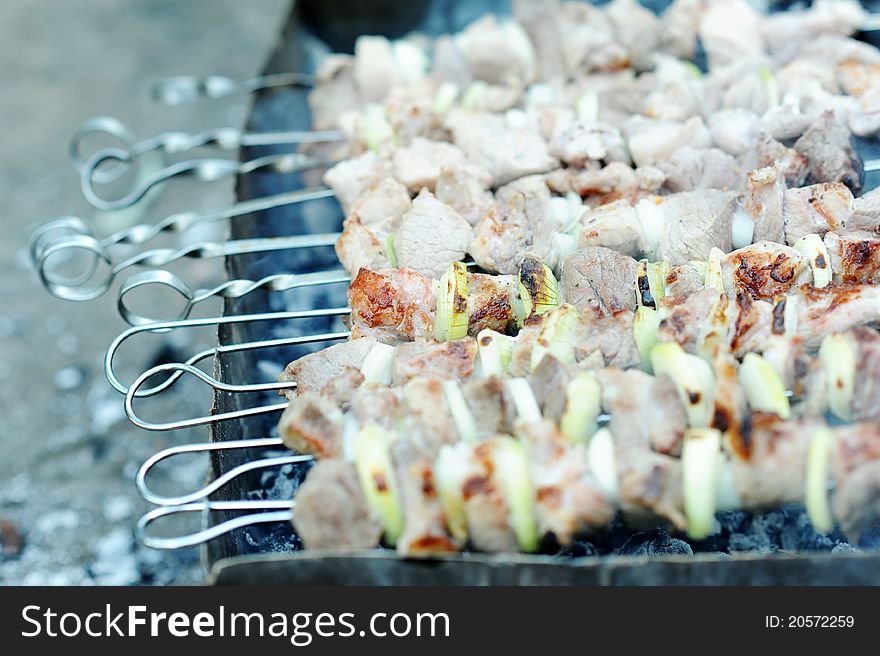 An image of raw meat and onions on skewers. An image of raw meat and onions on skewers