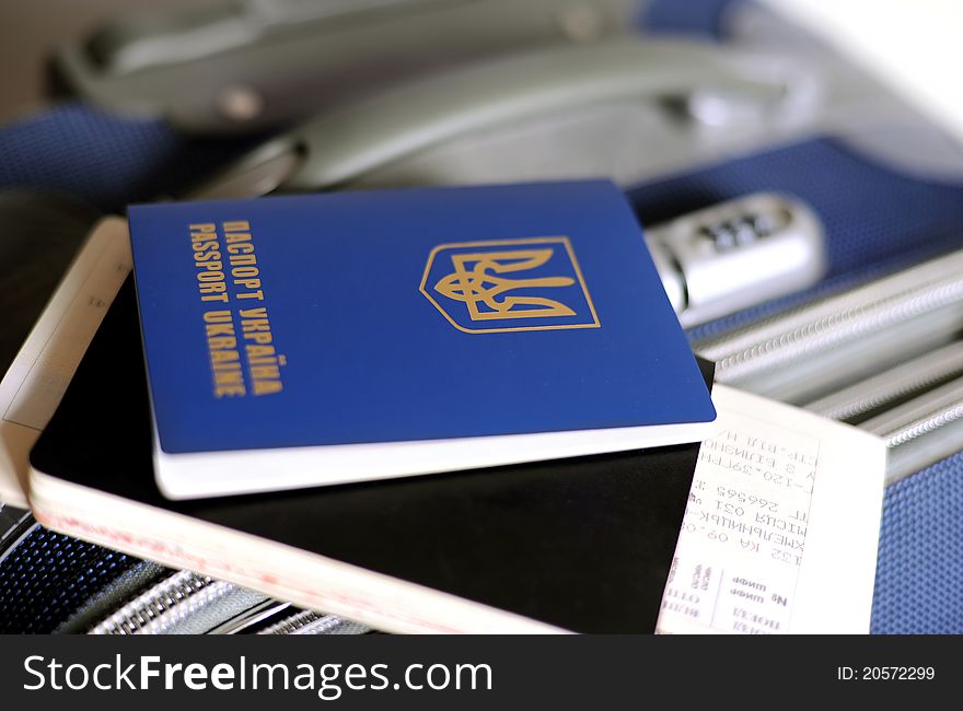 An image of a passport and tickets on a valise