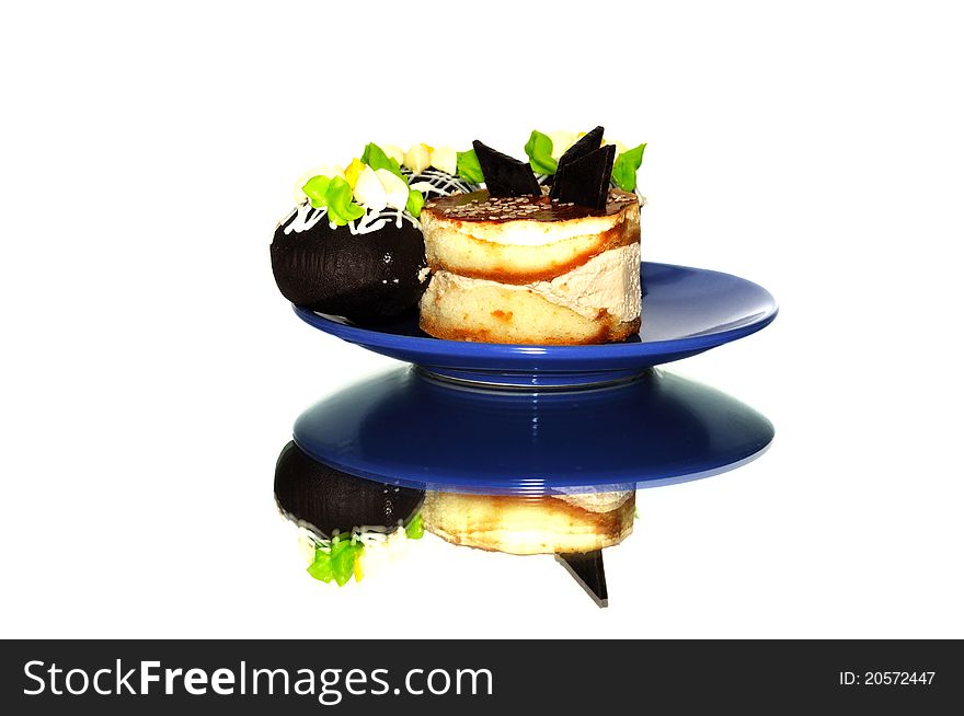 Small cakes with chocolate on a blue plate. Small cakes with chocolate on a blue plate