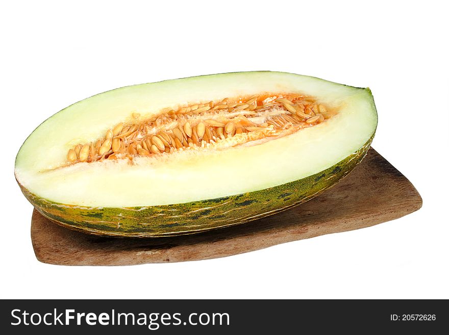 Melon on wooden plate in isolated over white background