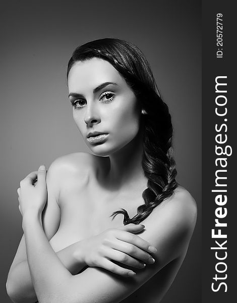 Close-up monochrome portrait of sexy caucasian young woman with beautiful hairstyle on grey background. Close-up monochrome portrait of sexy caucasian young woman with beautiful hairstyle on grey background