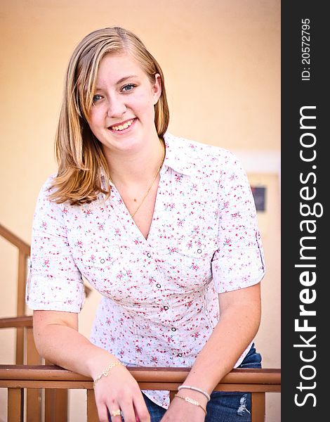 Young teenage girl leaning on a banister. Young teenage girl leaning on a banister