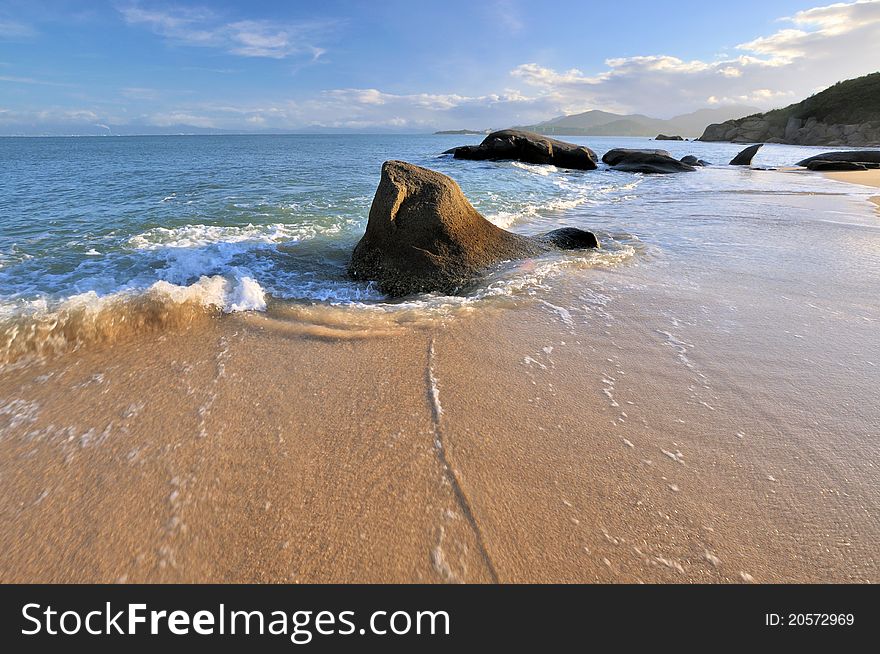 Rocky on sea beach coast under sunset lighting, shown as featured light, color and physiognomy. Rocky on sea beach coast under sunset lighting, shown as featured light, color and physiognomy.