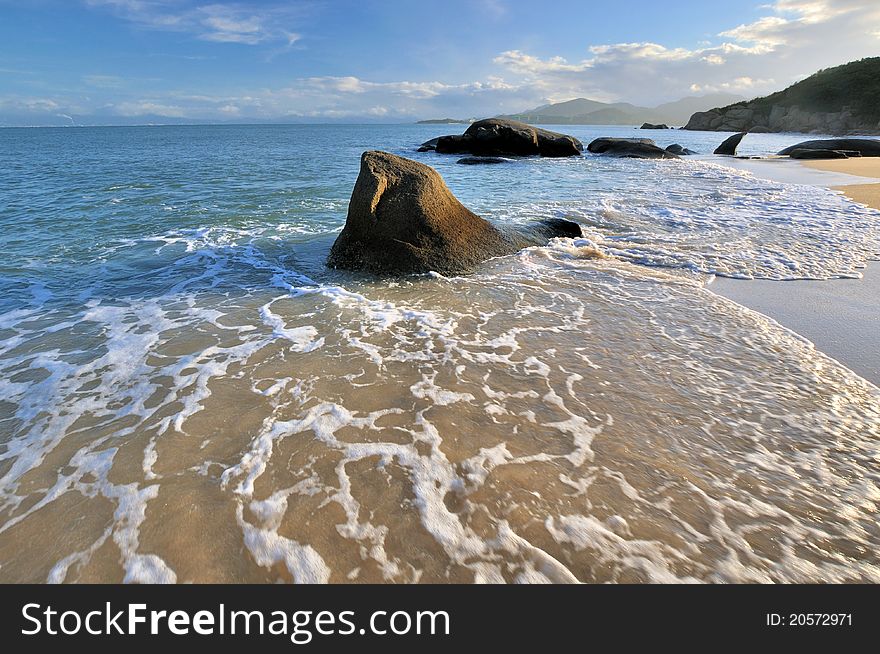 Rocky on sea beach coast under sunset lighting, shown as featured light, color and physiognomy. Rocky on sea beach coast under sunset lighting, shown as featured light, color and physiognomy.