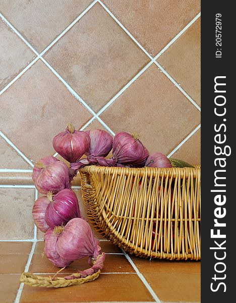 Onion in basket in kitchen, shown as kitchen interior and home life. Onion in basket in kitchen, shown as kitchen interior and home life.