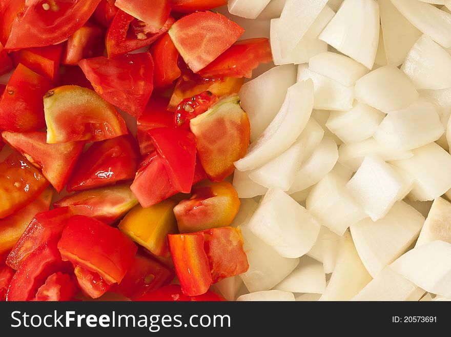 Pieces of tomato and onion prepare for cooking