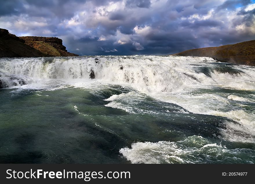 Cascade of Gullfoss (Golden waterfall) and dramatic sky, Iceland