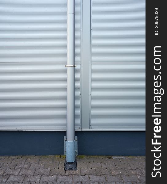 Part of exterior of a warehouse, metal gutter and wall. Modern look.