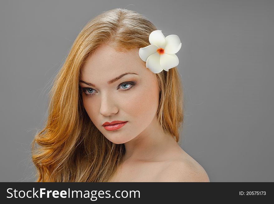 Portrait of redheaded beautiful girl on grey. Portrait of redheaded beautiful girl on grey