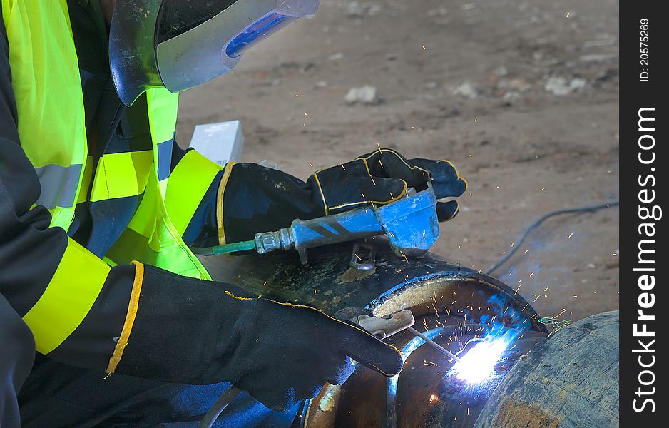 Welder covered with  protective mask