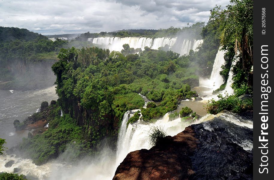 IguazÃº Falls, lie on the Argentina - Brazil border and are a UNESCO World Natural Heritage Site. IguazÃº Falls, lie on the Argentina - Brazil border and are a UNESCO World Natural Heritage Site.