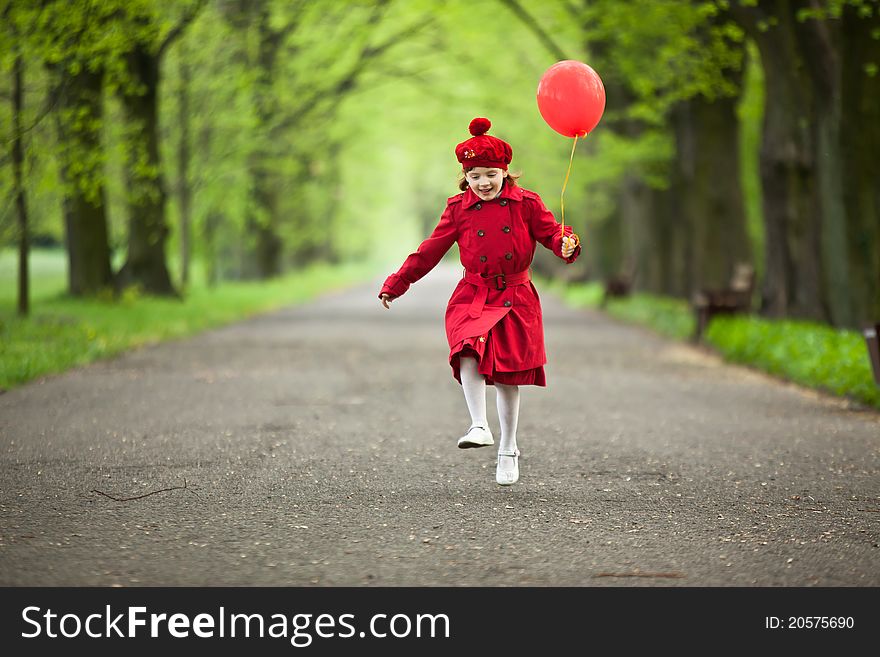 Girl wear in red coat, jumping in park alley, holding red balloon. Girl wear in red coat, jumping in park alley, holding red balloon