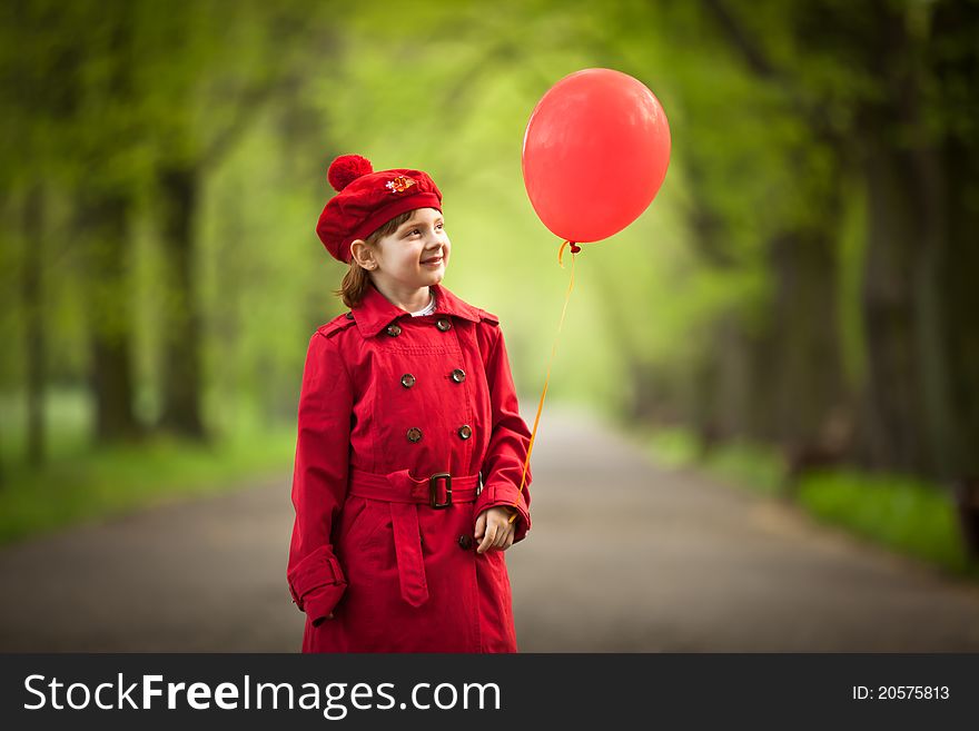 Girl wears in a red coat holding red balloon. Girl wears in a red coat holding red balloon