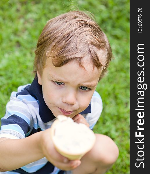 Small child eating ice cream in park