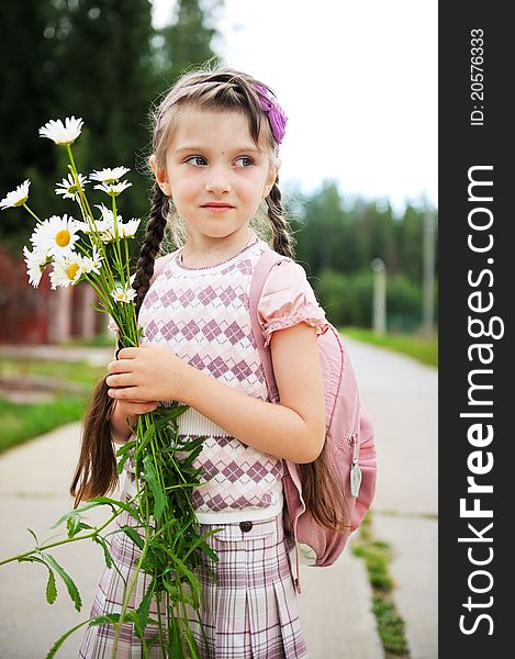 Young girl with pink bagpack ready for school