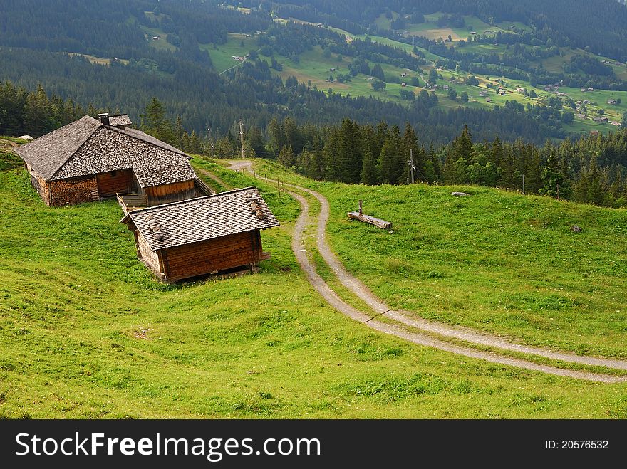 Little wood houses in the mountains of Swiss, small roads following. Little wood houses in the mountains of Swiss, small roads following