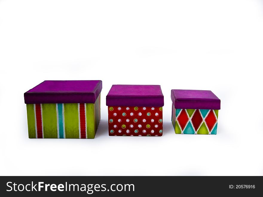 Presents a box on a white background in the green and red with purple lid. Presents a box on a white background in the green and red with purple lid
