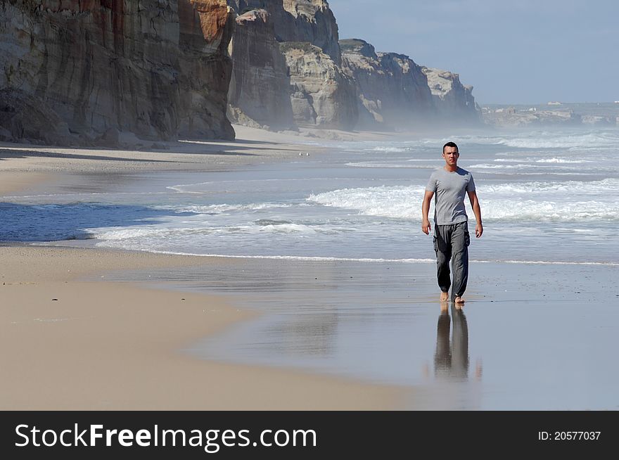 Latino man walking on a beach