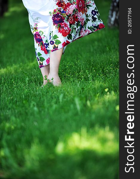 Woman's feet walking barefoot on grass. summer's day. Woman's feet walking barefoot on grass. summer's day