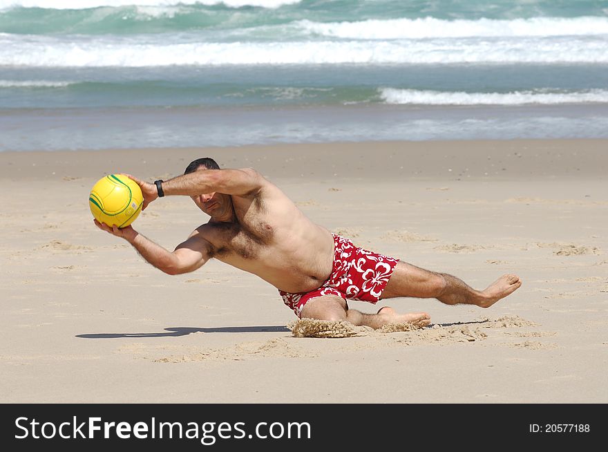 Fat man playing with a ball on the beach
