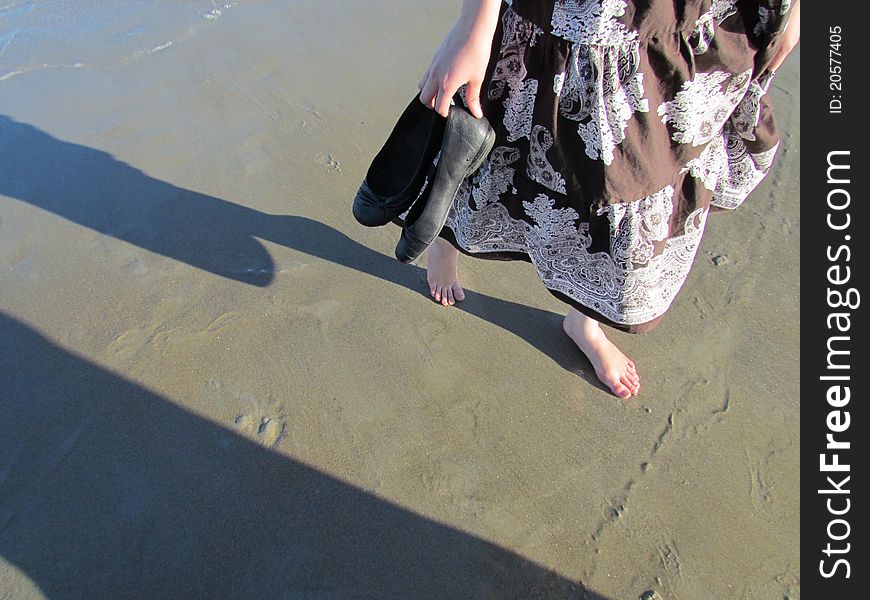 Walking barefoot on the wet sand as the water washes away your prints. Walking barefoot on the wet sand as the water washes away your prints