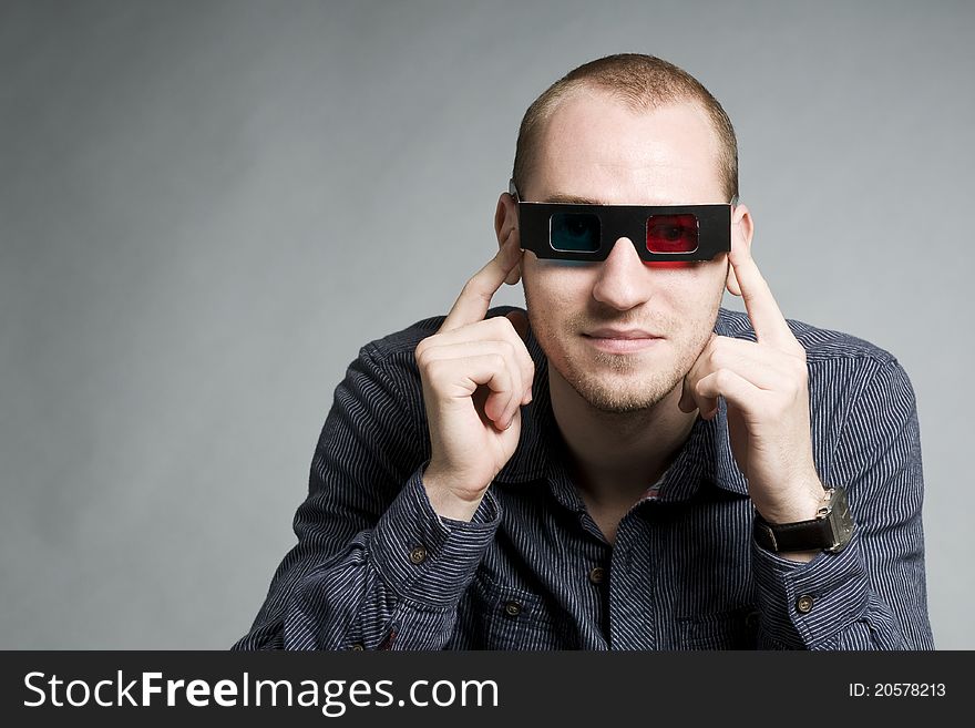 Young man watching movie with 3d glasses