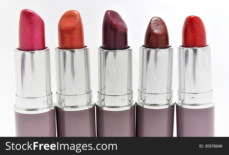 Lipsticks in different colours isolated on white - copy space