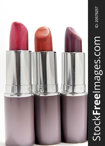 Three lipsticks in different colours - copy space