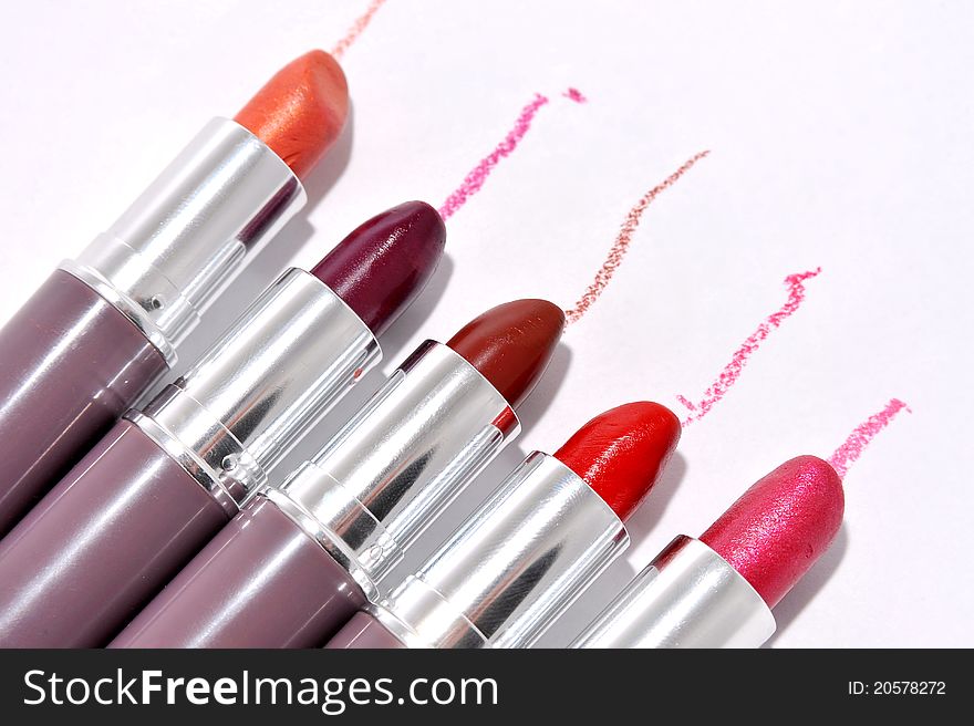 Lipsticks in different colours with trace - copy space