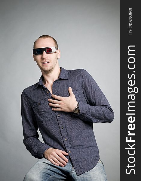 Young man watching movies with 3d glasses