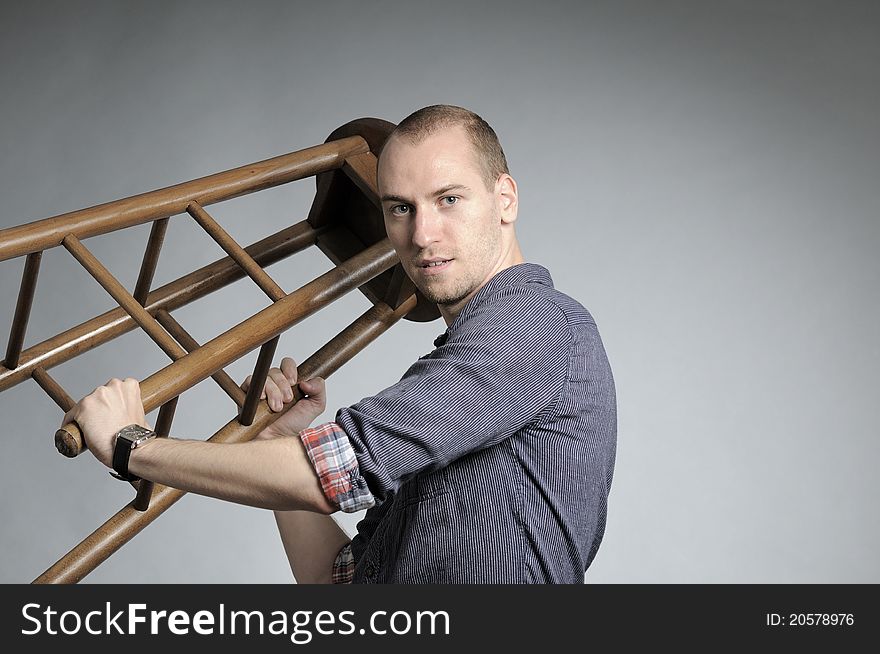 Angry white business man challenging with chair. Angry white business man challenging with chair