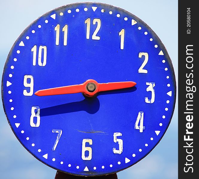 Blue clock background, quarter to tree. White numbers on blue background.