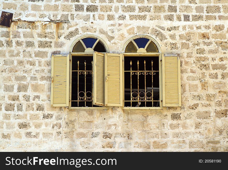 Asian stlyle windows in a yellow brick wall