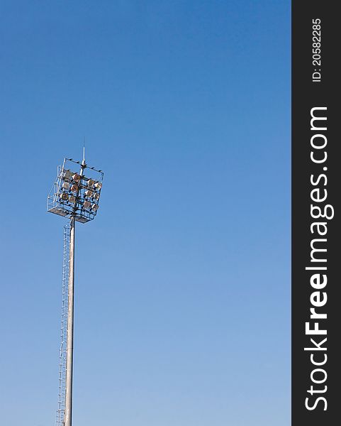 Sport light pole against blue sky background