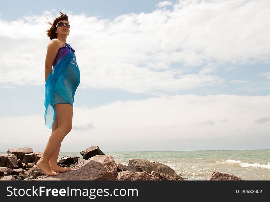 Young pregnant woman on sea coast
