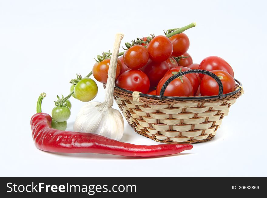 Ripe tomatoes in basket and pepper. Ripe tomatoes in basket and pepper