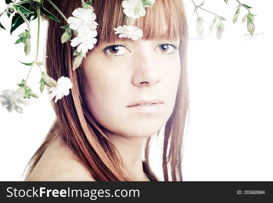 Beauty face of the young beautiful woman with flowers