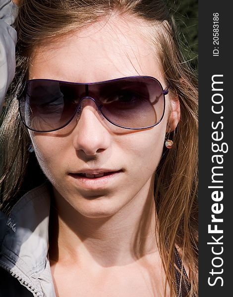 woman with sunglasses and long brown hair