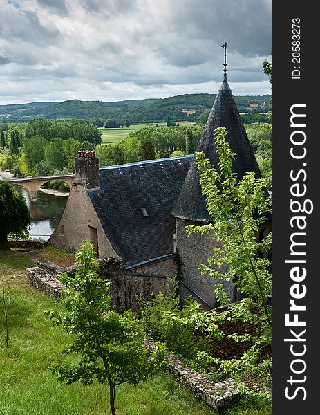 French Chateau with view of river behind and storm clouds