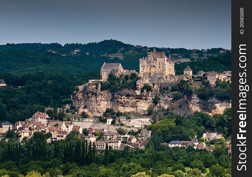 View of a French village and Chateau on a hillside. View of a French village and Chateau on a hillside