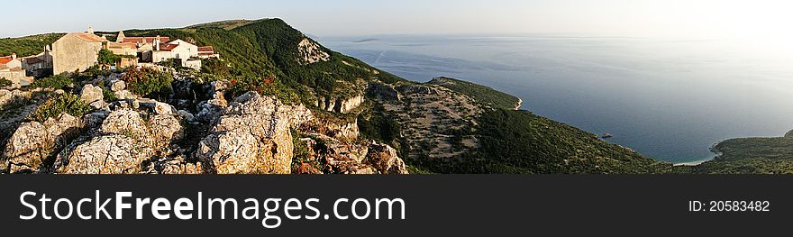 Panoramic view of a small Mediterranean village high above the coastline. Panoramic view of a small Mediterranean village high above the coastline