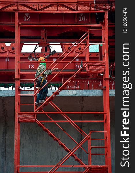 Construction workers on a scaffold ladder.