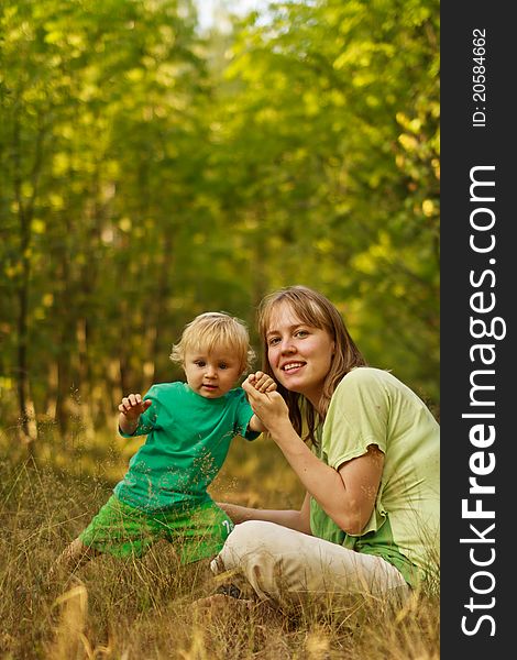 Active baby in summer nature with mother. Active baby in summer nature with mother