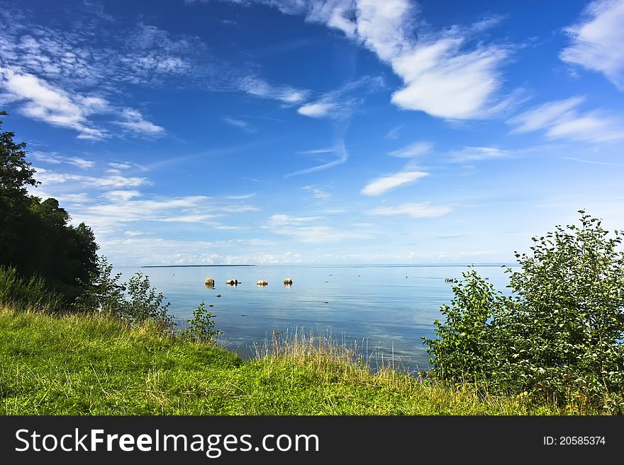 Idyllic seashore landscape with green grass, blue sky and vivid clouds. Idyllic seashore landscape with green grass, blue sky and vivid clouds