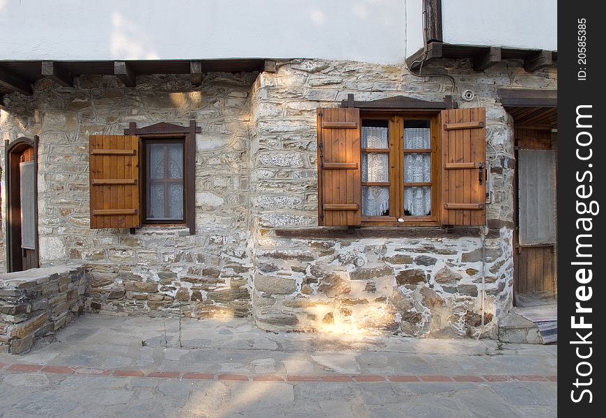 Old stone house with wooden doors windows and balkony in a greek vilage in halkidiki