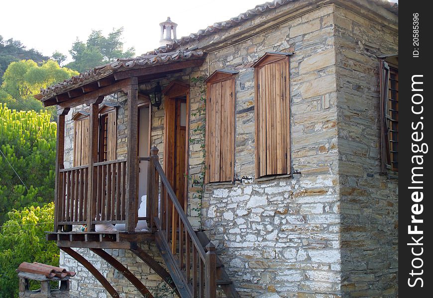 Old stone house with wooden doors windows and balkony in a greek vilage in halkidiki