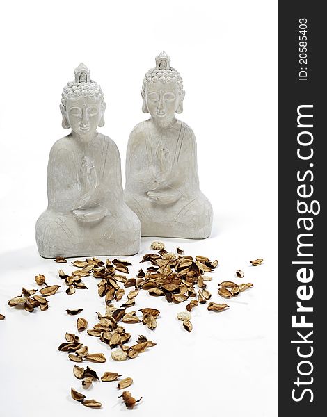 Two white budha statues made out of wood with potpourri. Two white budha statues made out of wood with potpourri